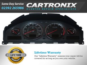 Volvo dashboard instrument cluster with speedometer, tachometer, and warning lights displayed.